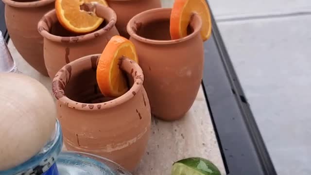 The Castillos making alcohol drinks (palomas) with the Guzmans