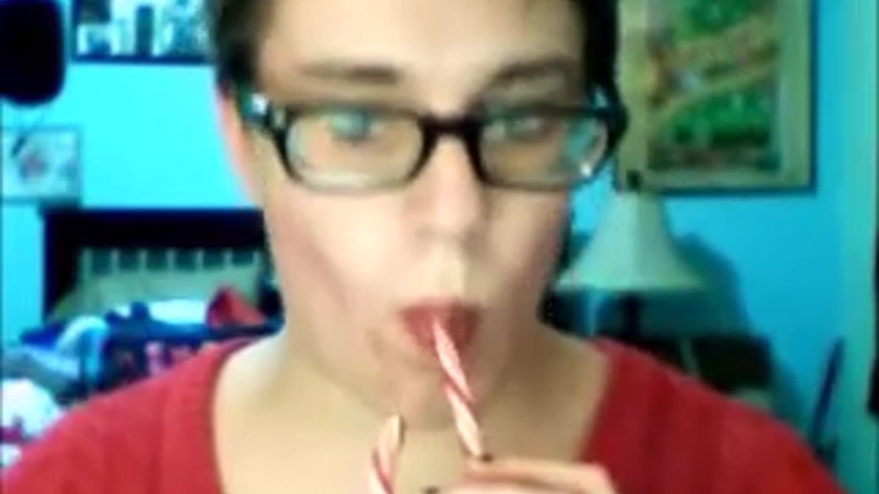 Anna sucks a candy cane like a penis.