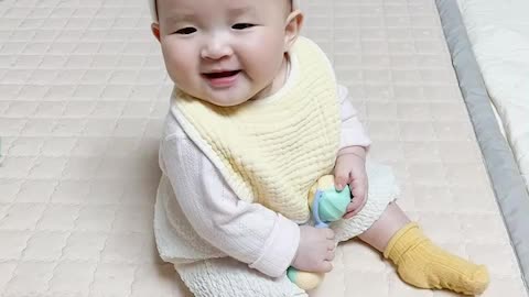 Baby passionately playing with toys