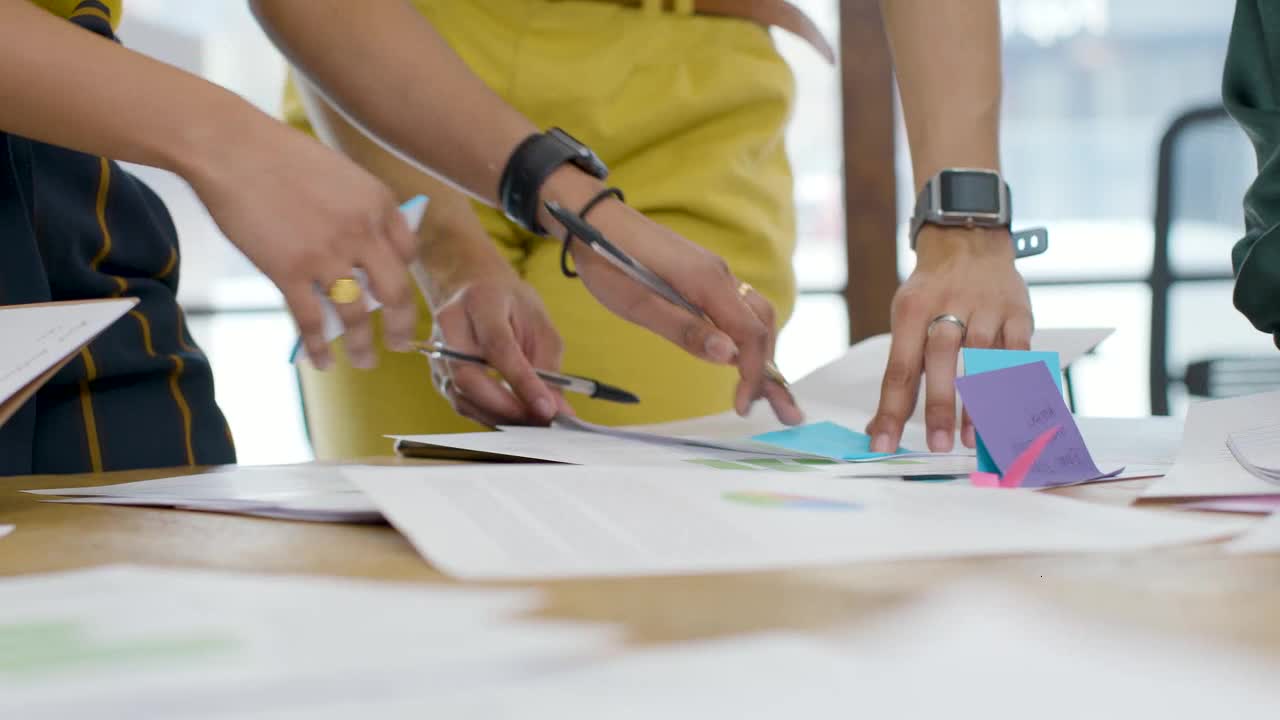 Woman Writing On Post It Note During Meeting