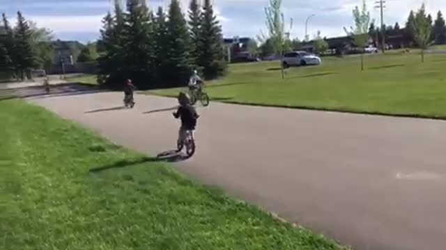 Little boy rides bike and crashes into another bike