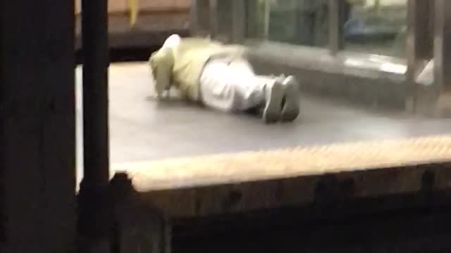 Man white pants doing push ups elevator