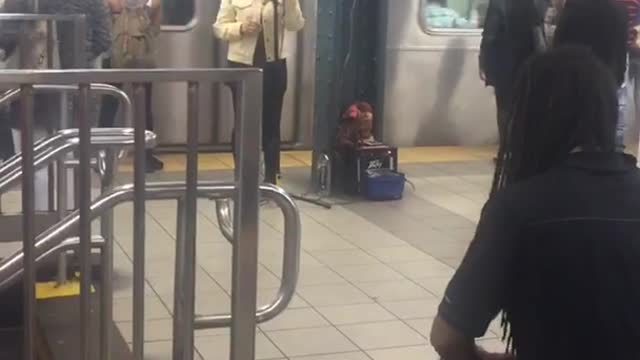 Woman sings man plays drums subway