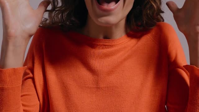 A Joyful and Amazed Woman Smiling at the Camera
