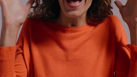 A Joyful and Amazed Woman Smiling at the Camera