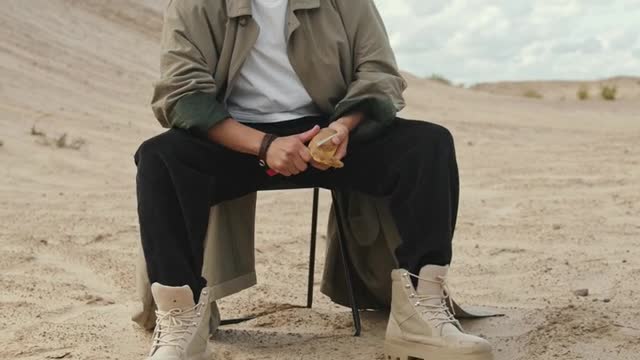 Man Peeling a Potato at the Desert