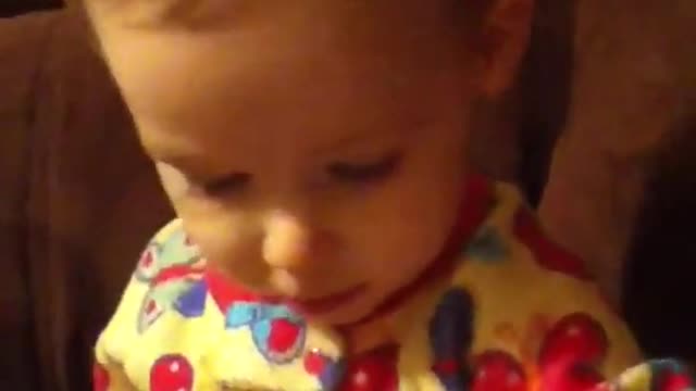 Emma reading as a baby