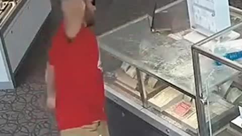 American man stealing in jewelry store with bricks: smashing counters 9 times without success