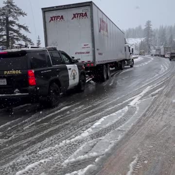 Highway Patrol Helps Trucker up Interstate 80 over Donner Summit in California.