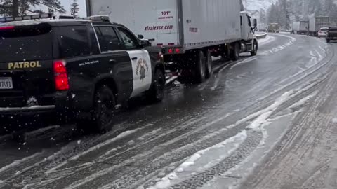 Highway Patrol Helps Trucker up Interstate 80 over Donner Summit in California.