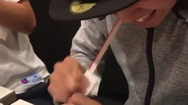 Man heats up a straw and then stretches it