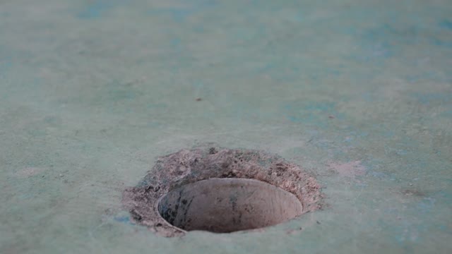 Playing Golf/the Ball rolls past the hole.