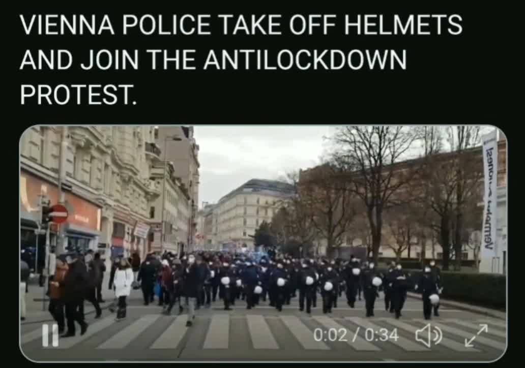 VIENNA POLICE TAKE OFF HELMETS AND JOIN THE ANTILOCKDOWN PROTEST.