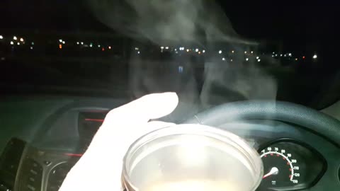 Coffee in the car . By a river