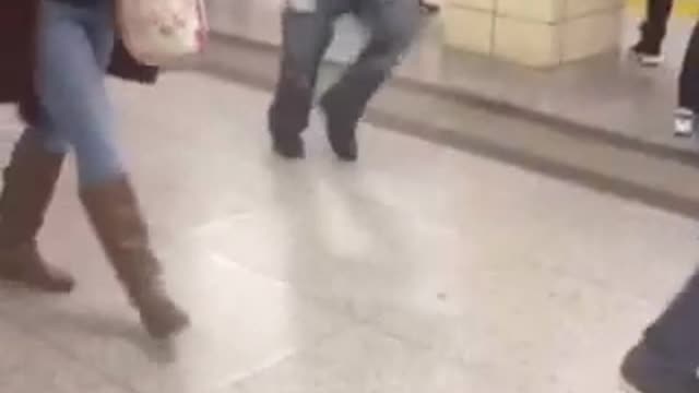 Guy green jacket black puffy jacket dancing subway