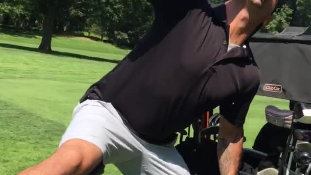 Guy black shirt on golf cart drinking beer