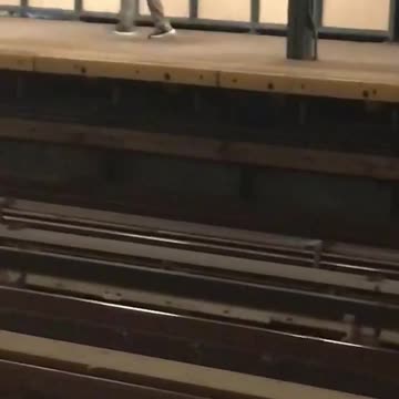 Man in a green sweater dancing in a subway station