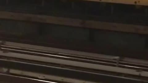 Man in a green sweater dancing in a subway station