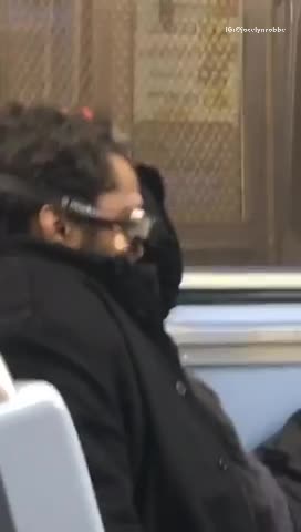 Black coat man wears swim goggles on subway