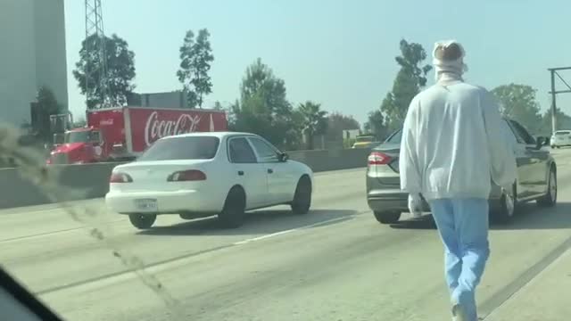 Mentally Ill Man in Bandages Walks on Highway