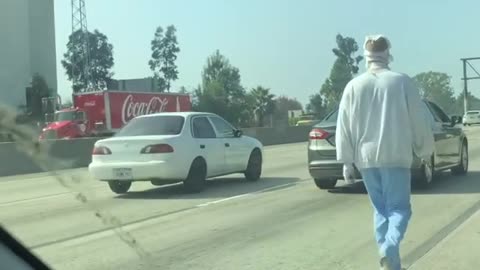 Mentally Ill Man in Bandages Walks on Highway