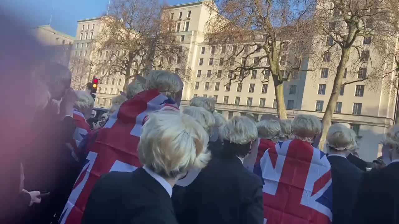 Crowd dressed like Boris Johnson party outside Downing Street.