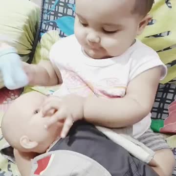 Cute baby playing with doll