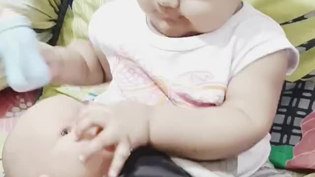 Cute baby playing with doll