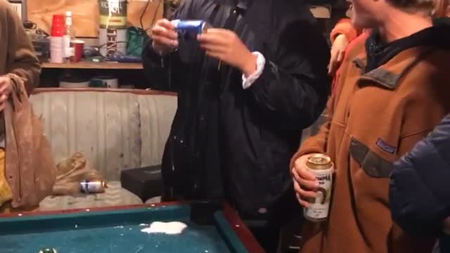 Guy playing pool hits drink with ball