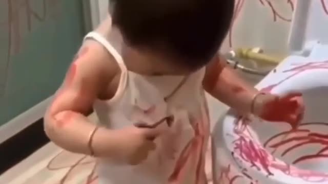 Cute baby writing with lipstic