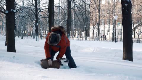 oung bearded man playing with and his cute friend English bulldog