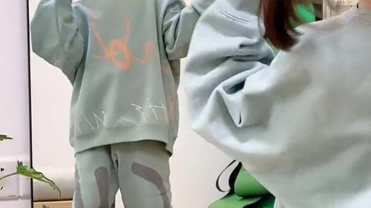 cute baby dancing in front of the mirror is very happy and beautiful
