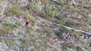 Talented Dude Catches Football while Balancing on High Slackline