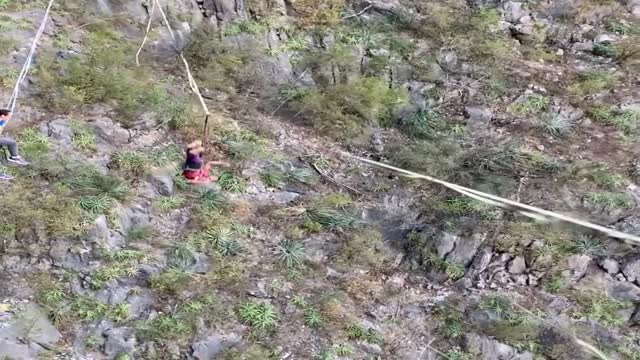 Talented Dude Catches Football while Balancing on High Slackline