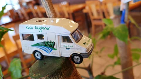 A miniature car on a flowerpot