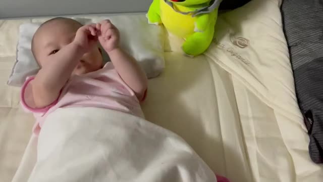 Baby playing with the doll