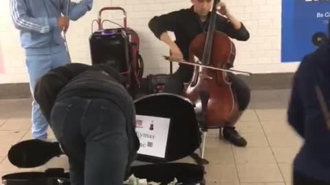Homeless guy takes some money out of case of kids performing subway