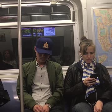 Guy blue hat green jacket falling asleep wobbling around