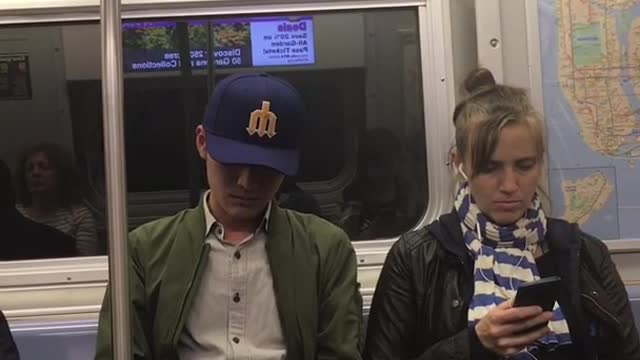 Guy blue hat green jacket falling asleep wobbling around