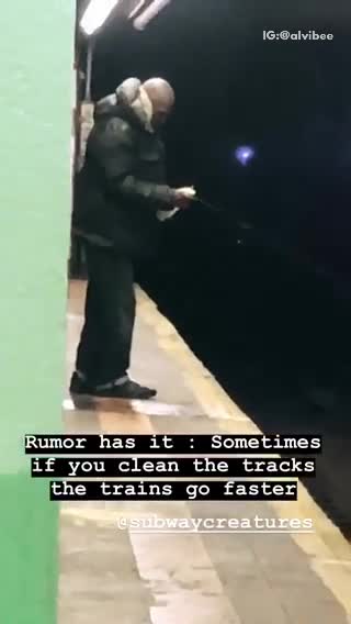 Man sprays water on subway track