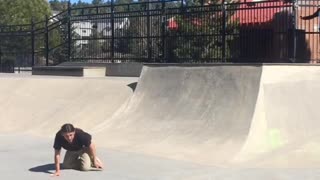 Black shirt skateboarder turns ankle