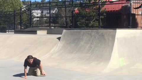 Black shirt skateboarder turns ankle