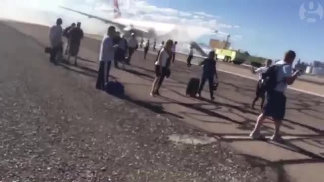 Evacuated passengers flee after British Airways plane catches fire