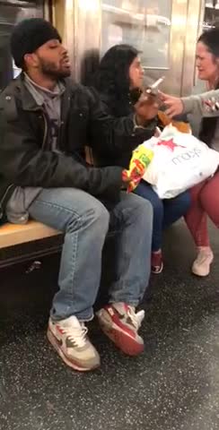 Man and woman smoking joint passing weed across subway