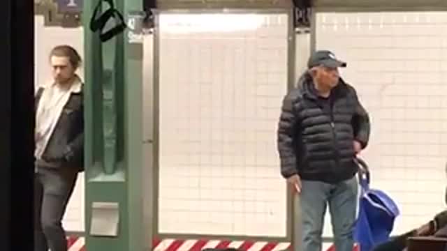 Man does push ups off bench with spinning handle at subway station