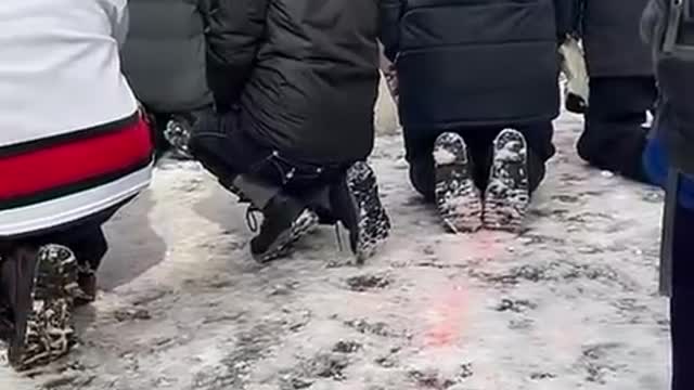 Protestors praying in front of police