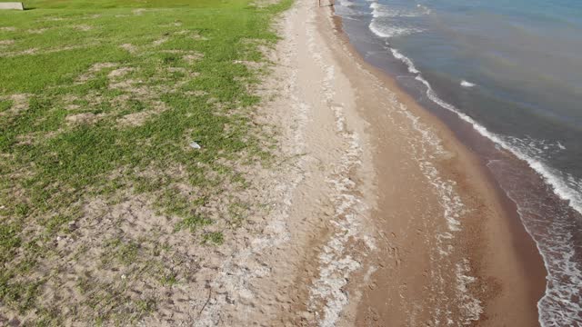 Walking on the beach of Issyk-Kull lake in Kyrgyzstan