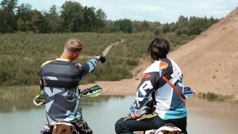 Two Motorcyclists Talking in the Outdoors