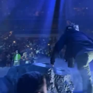 Travis Scott gets pushed off stage by a prop