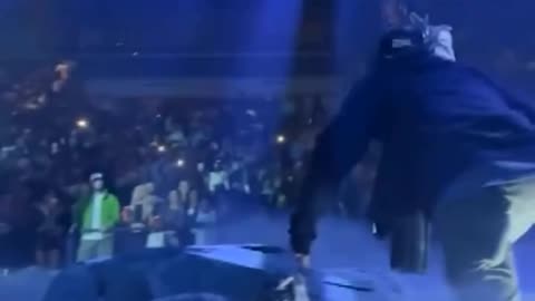 Travis Scott gets pushed off stage by a prop